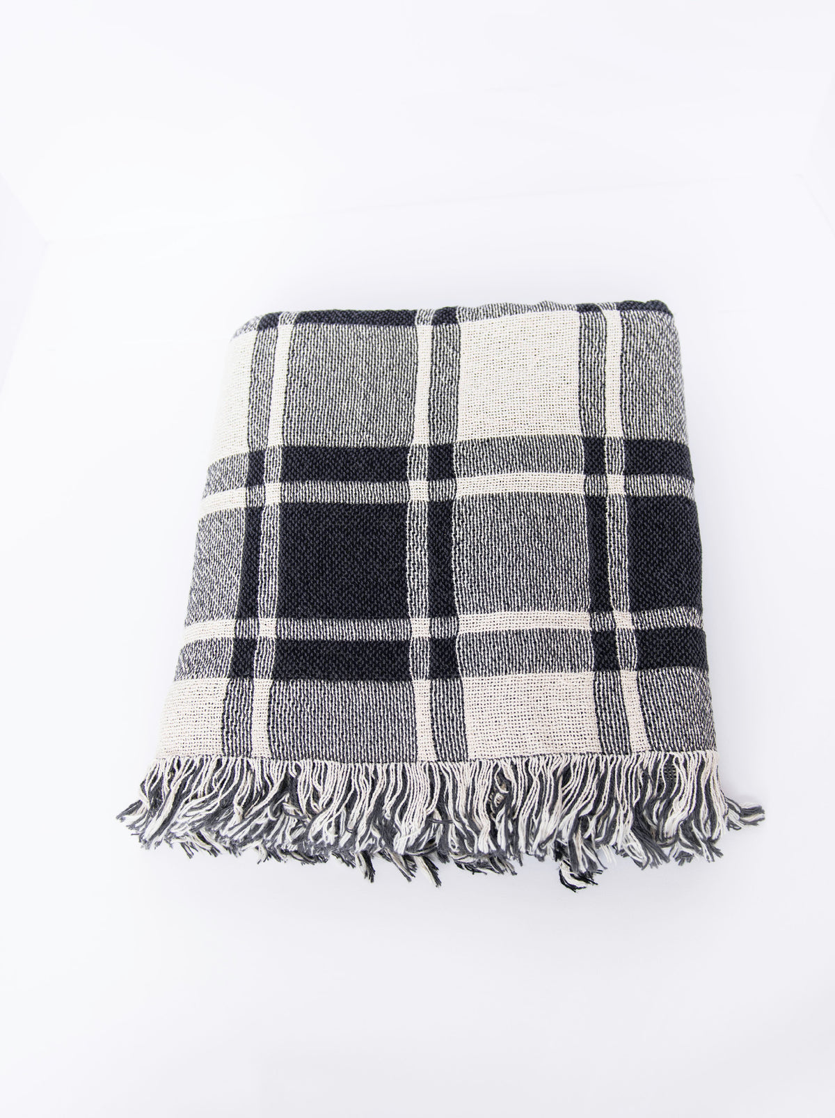 Overhead view of folded Ellis neutral plaid woven throw with fringe