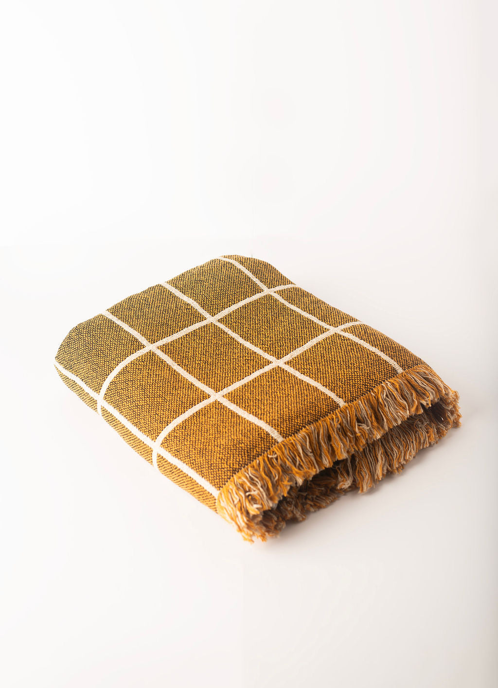 Folded Greer Acorn golden brown grid reversible jacquard woven throw blanket