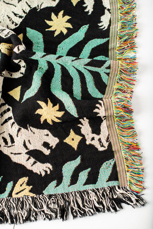 Close-up of Leona Verdant green, black, and cream tiger folk-art woven cotton throw with fringe