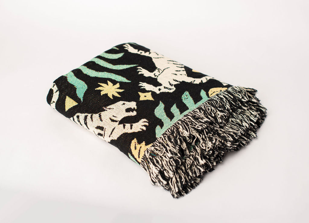 Folded Leona Verdant tiger jacquard woven throw blanket with black and cream fringe