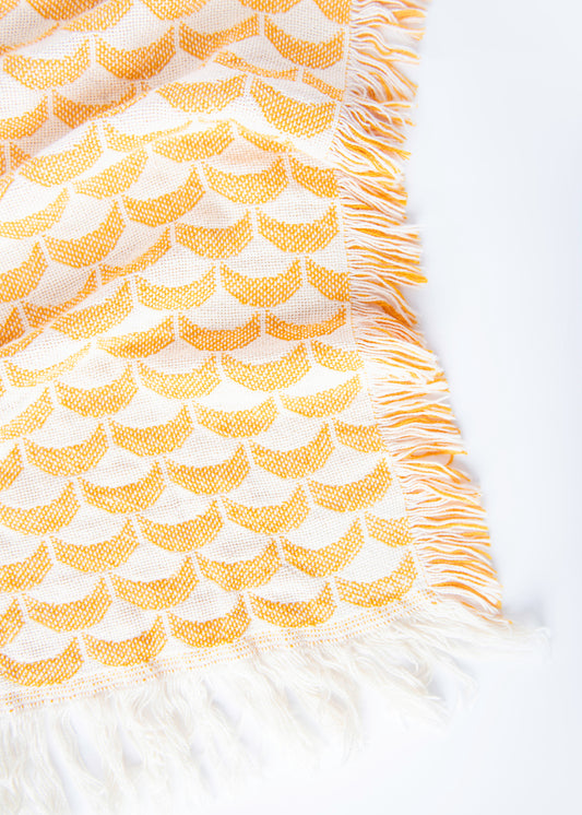 Close-up of Sadie golden yellow and cream scallop woven cotton throw with fringe